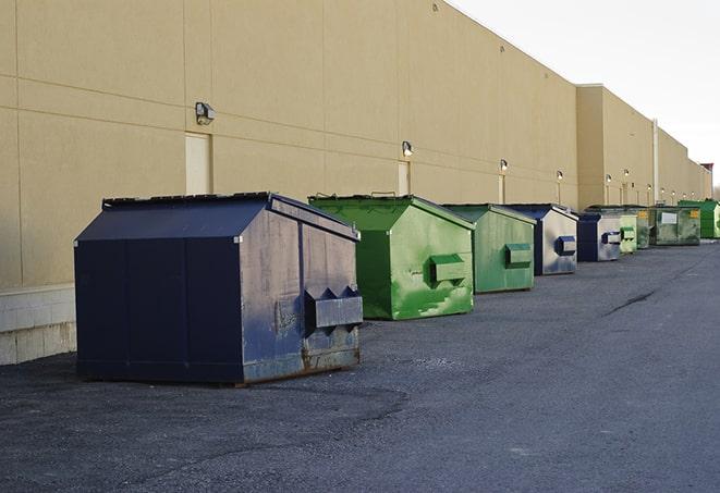 a crowd of dumpsters of all colors and sizes at a construction site in Alhambra, IL